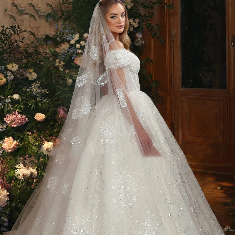 2024 Luxury Lace Ball Gown Wedding Dress with Beading and Spaghetti Straps.