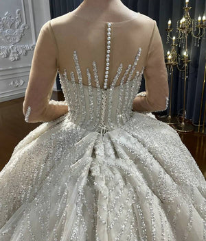 Luxury Beaded Ball Gown Wedding Dress with Long Sleeves and Elegant Detailing