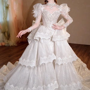 Customized Superfine O-Neck Full Sleeve Wedding Dress with Tiered Bow and Sequins